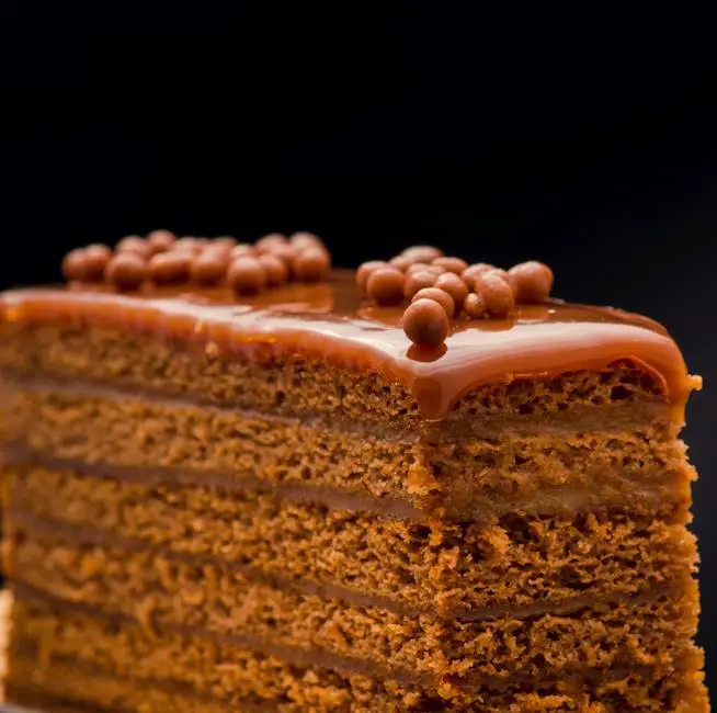 A beautifully decorated Belgian chocolate cake with various toppings and garnishes.